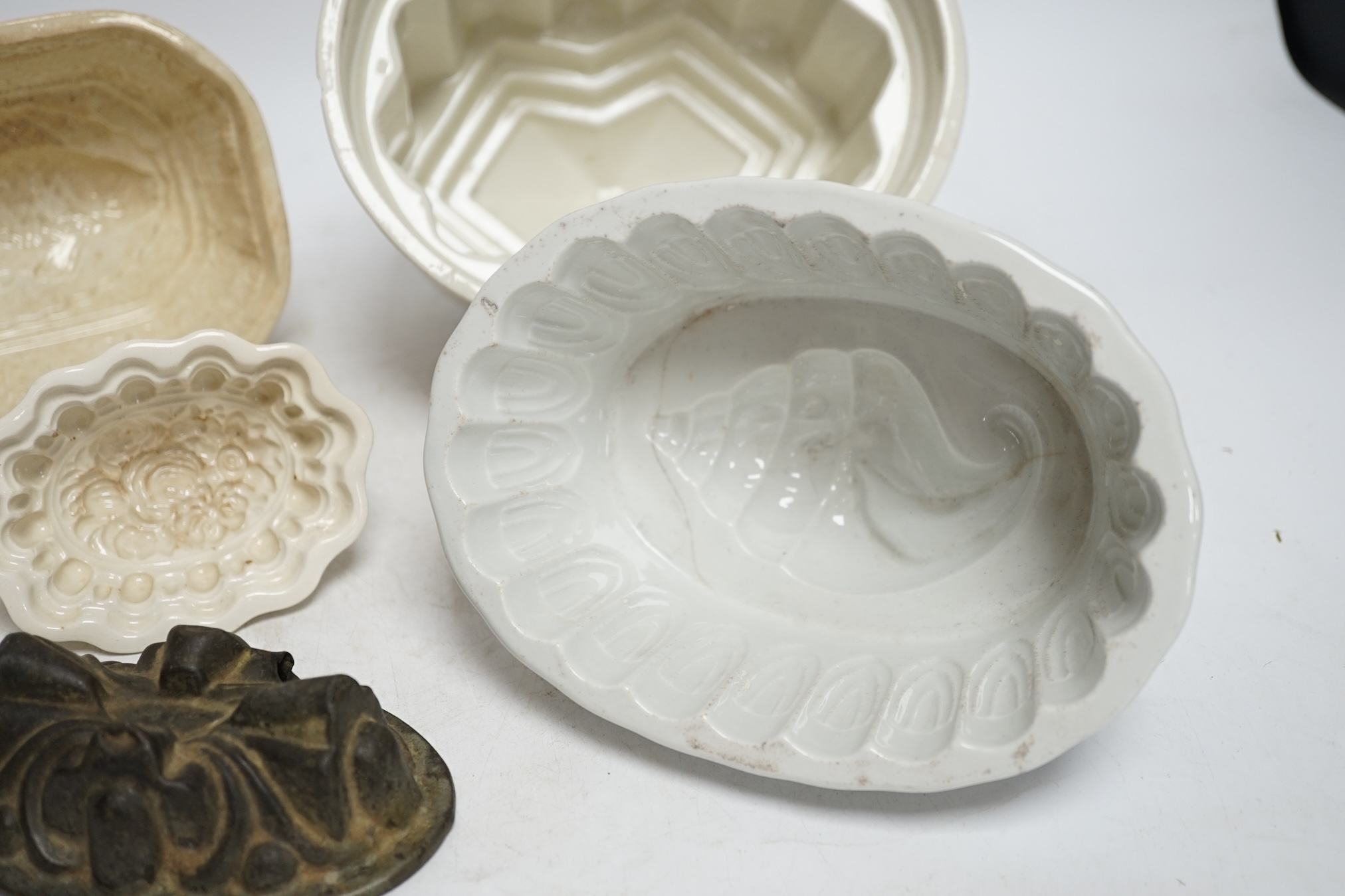 From the Studio of Fred Cuming. Seven jelly moulds including six ceramic examples, one Cetemware, largest 17cm wide. Condition - fair, one cracked